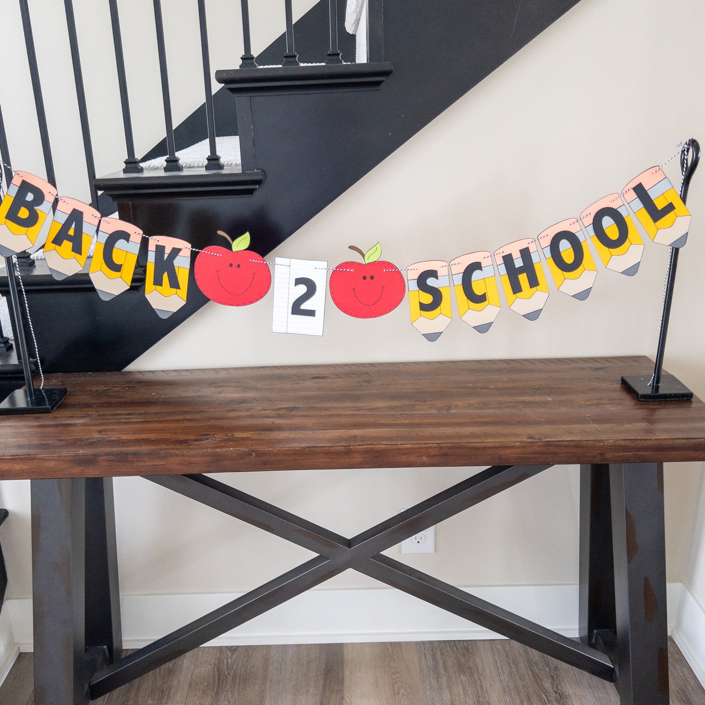 A 'Back to School' themed banner made of paper letters spelling out the phrase, with decorative elements such as apples and pencils, and a piece of lined paper.