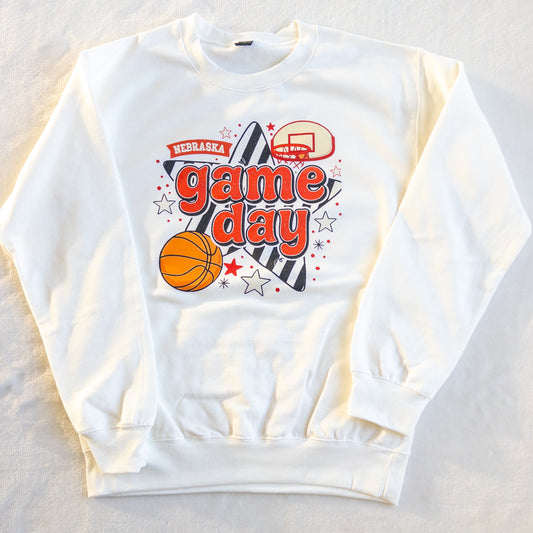 White sweatshirt with 'Nebraska game day' text and basketball graphics