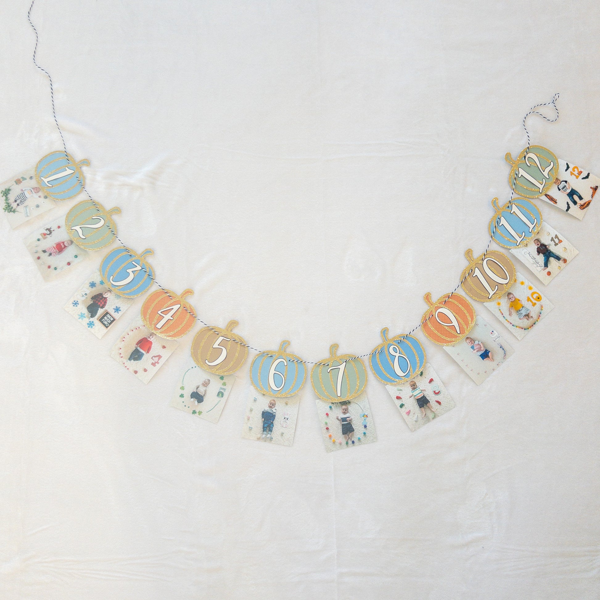 A Pumpkin-Themed First Birthday Milestone Photo Custom Banner with various monthly markers and pumpkin designs.
